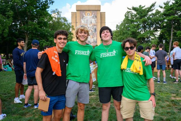 Welcome Weekend. Four men standing in front of the Hesburgh Library