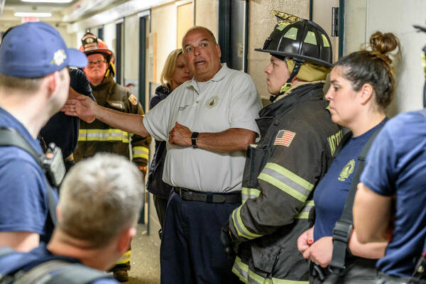 Asst. Fire Chief Tim Hoeppner talks to firefighters.