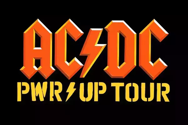 Orange 3D-style AC/DC logo with a yellow lightning bolt, above yellow stencil text "PWR⚡UP TOUR" also featuring a lightning bolt.